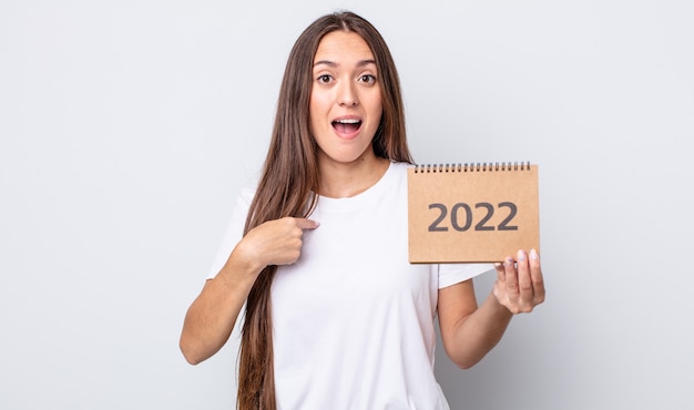 Young pretty woman feeling happy and pointing to self with an excited. 2022 planner concept