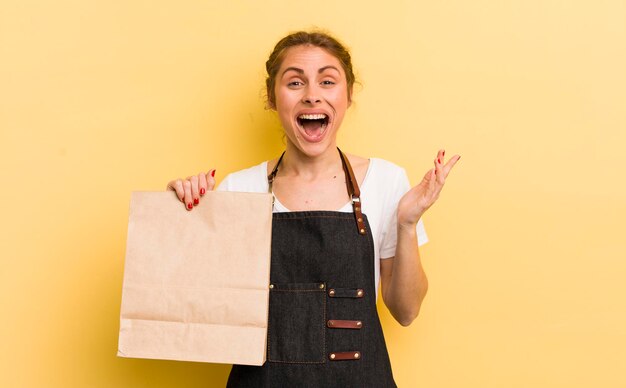 Young pretty woman feeling happy surprised realizing a solution or idea fast food courier concept