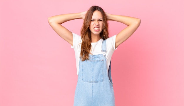 Young pretty woman feeling stressed, anxious or scared, with hands on head