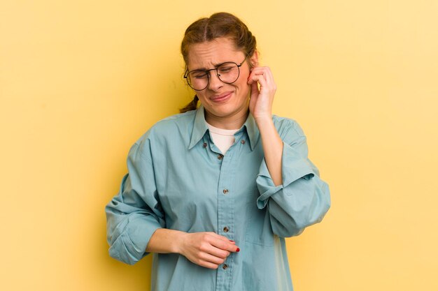 Young pretty woman feeling stressed frustrated and tired rubbing painful neck with a worried troubled look