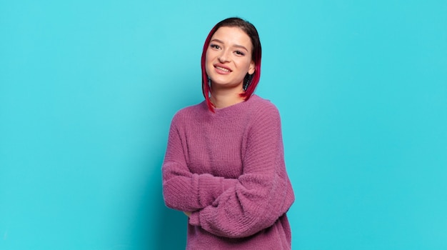 Young pretty woman gesturing on colored wall