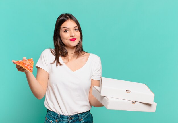 Young pretty woman happy expression and holding a pizza