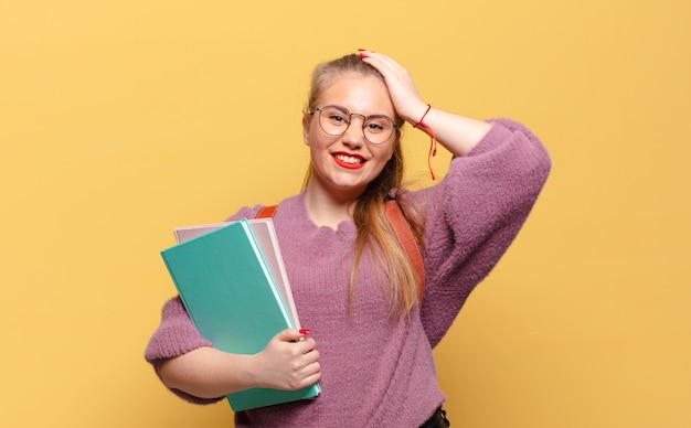 Young pretty woman happy and surprised expression student concept