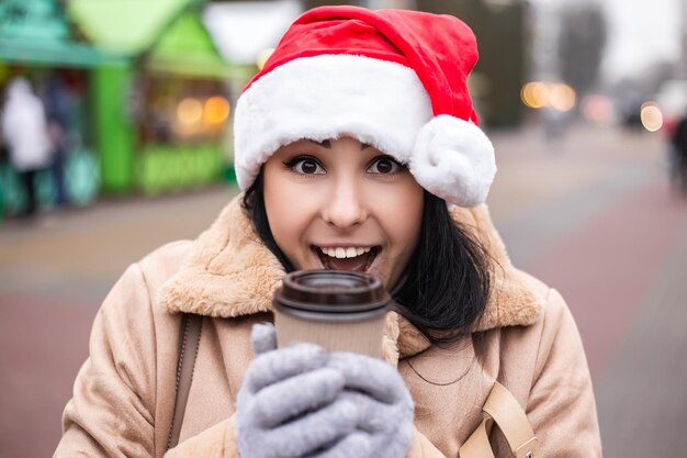 Young pretty woman hold hot beverage drink coffee