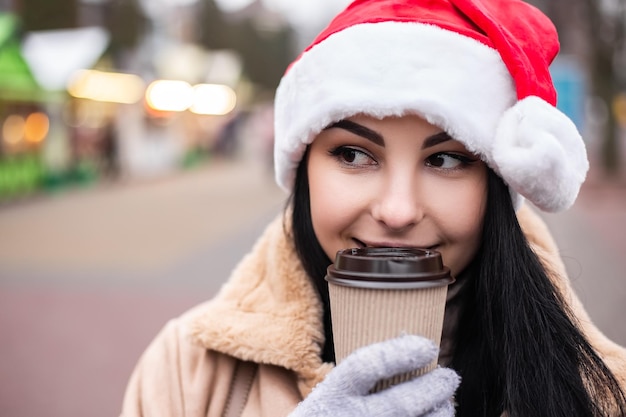 Young pretty woman hold hot beverage drink coffee