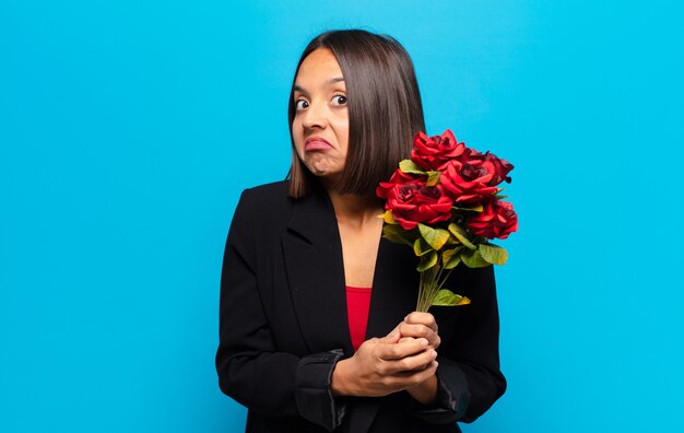 Young pretty woman holding a bouquet of roses