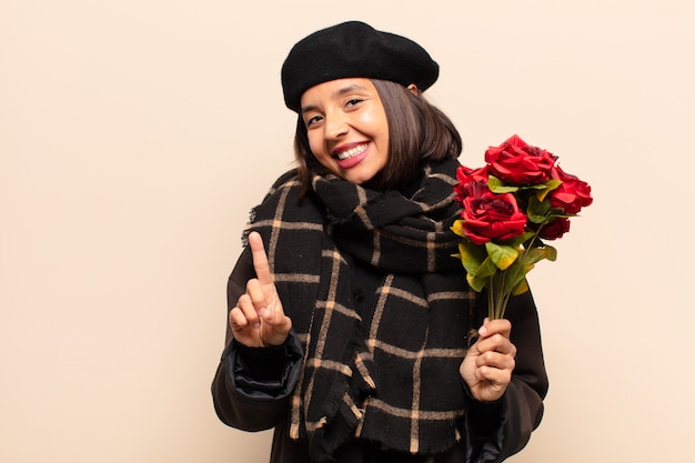 Young pretty woman holding a bouquet of roses