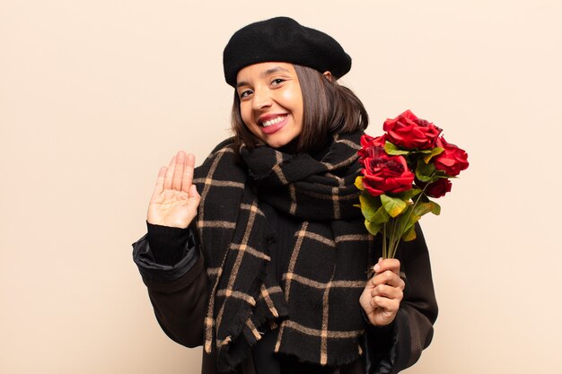 Young pretty woman holding a bouquet of roses