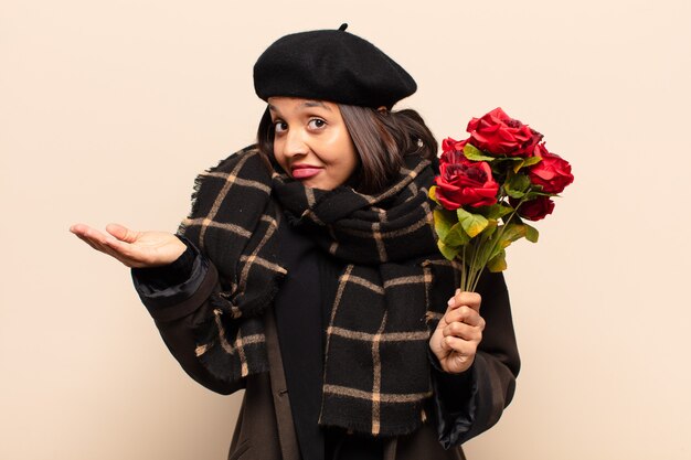 Young pretty woman holding a bouquet of roses