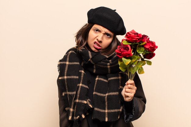 Young pretty woman holding a bouquet of roses