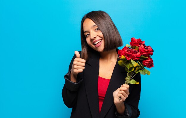 Young pretty woman holding a bouquet of roses