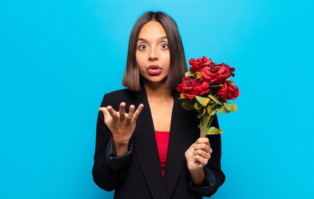Young pretty woman holding a bouquet of roses