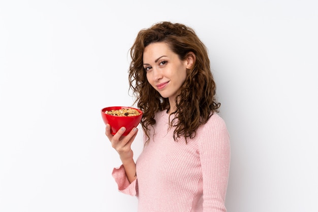 Young pretty woman holding a bowl of cereals