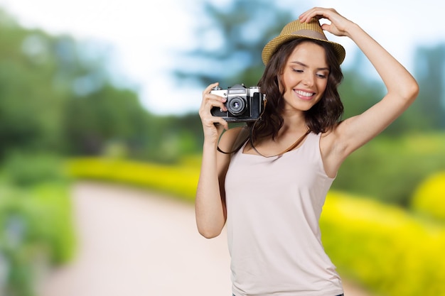 Young pretty woman holding camera