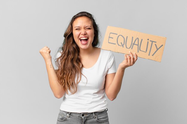 Young pretty woman holding a equality banner