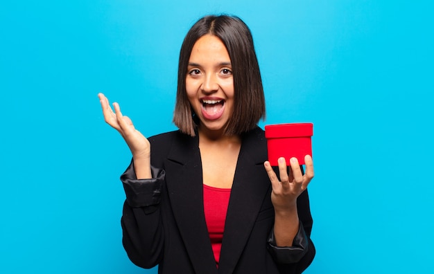 Young pretty woman holding a gift box