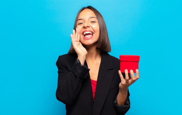 Young pretty woman holding a gift box