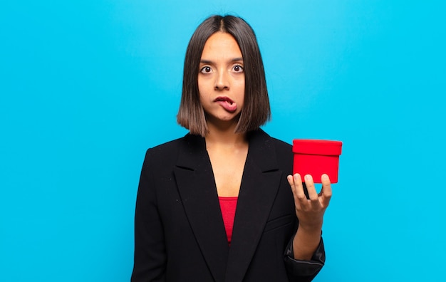 Young pretty woman holding a gift box