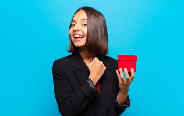 young pretty woman holding a gift box