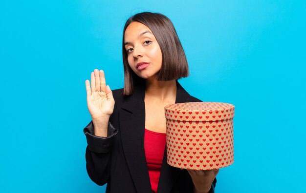 Young pretty woman holding a gift box