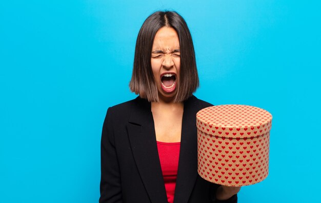 Young pretty woman holding a gift box