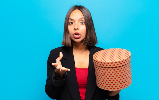 Young pretty woman holding a gift box