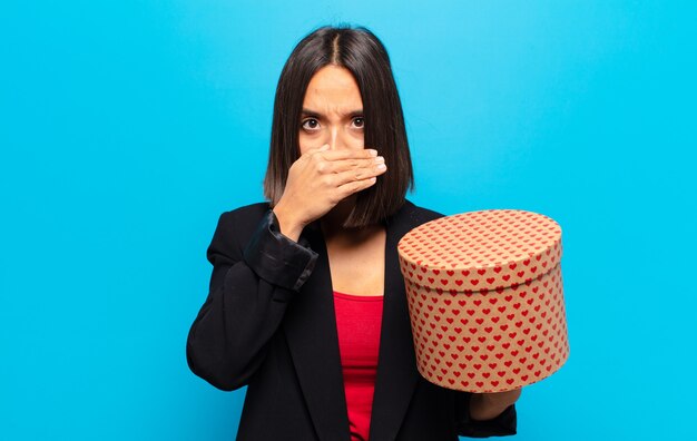 Young pretty woman holding a gift box