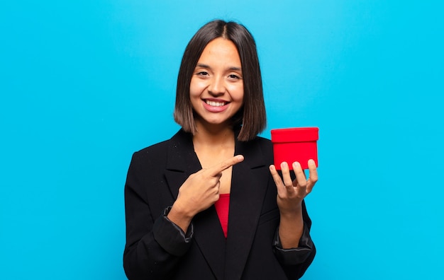 Young pretty woman holding a gift box