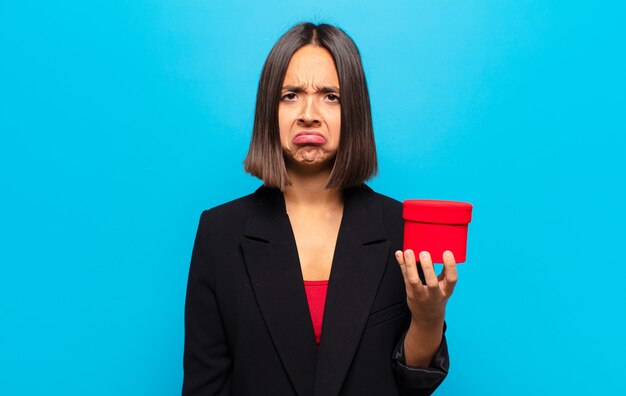 Young pretty woman holding a gift box