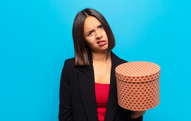 Young pretty woman holding a gift box