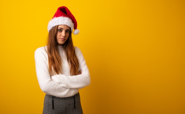 Young pretty woman holding gift looking straight ahead