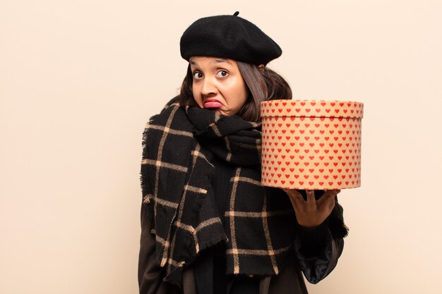 Young pretty woman holding a gift