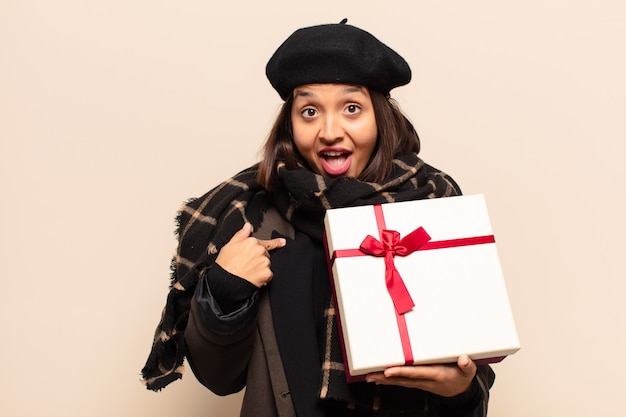 Young pretty woman holding a gift