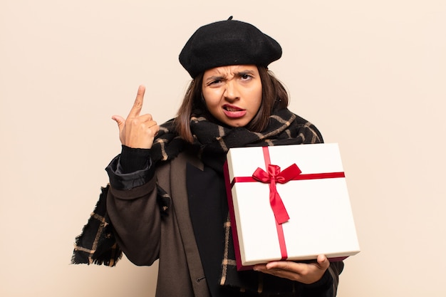 Young pretty woman holding a gift