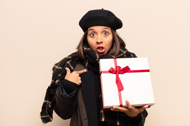 Young pretty woman holding a gift