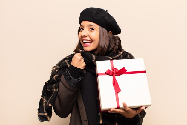 Young pretty woman holding a gift