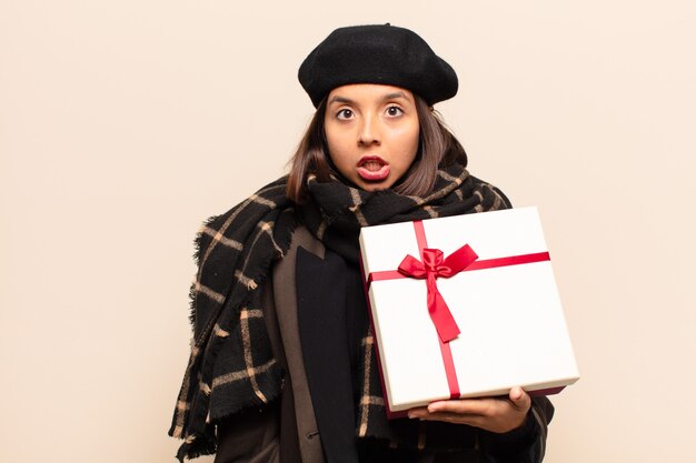 Young pretty woman holding a gift