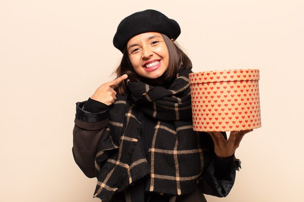 Young pretty woman holding a gift