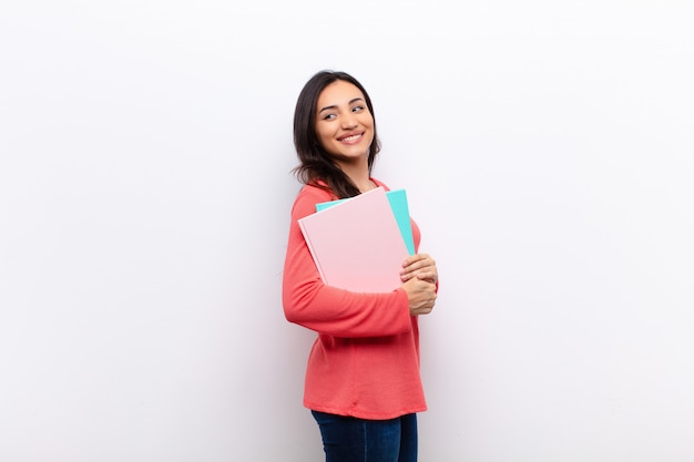 Young pretty woman holding notebooks