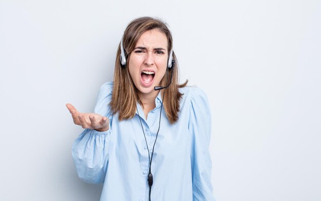 Young pretty woman looking angry, annoyed and frustrated. telemarketer concept