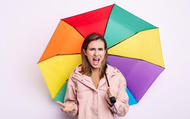 Young pretty woman looking angry, annoyed and frustrated. umbrella concept