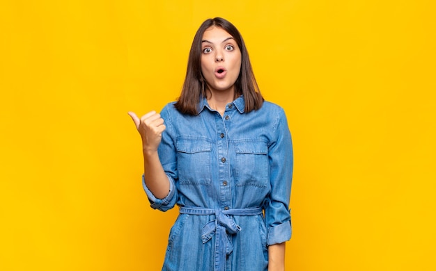 Young pretty woman looking astonished in disbelief isolated