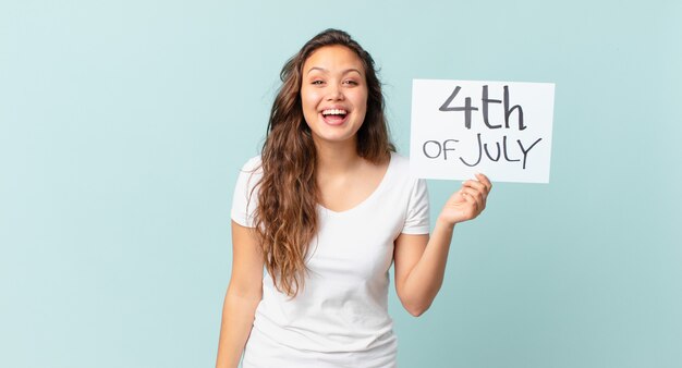 Young pretty woman looking happy and pleasantly surprised independence day concept