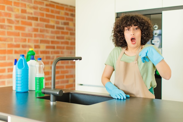 Photo young pretty woman looking shocked and surprised with mouth wide open, pointing to self