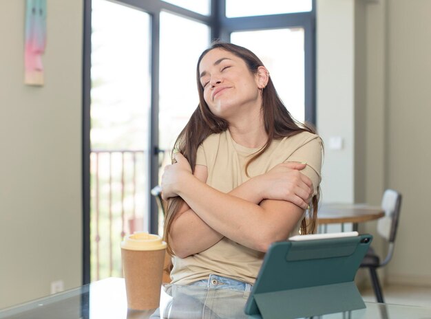 young pretty woman looking shocked and surprised with mouth wide open pointing to self