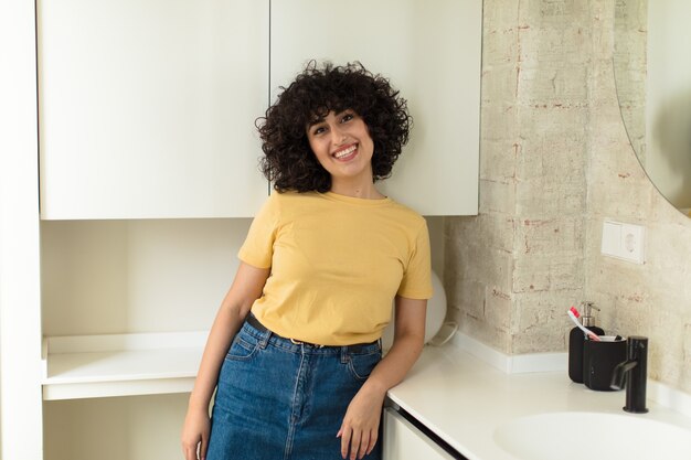 Young pretty woman in a new home bathroom