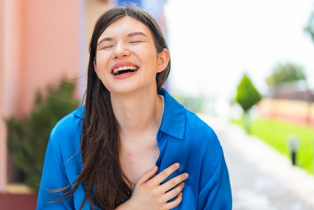 Young pretty woman at outdoors smiling a lot