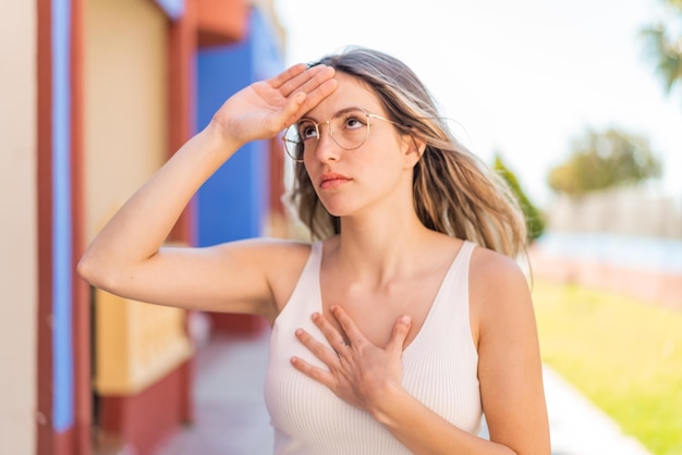 Young pretty woman at outdoors With glasses and tired