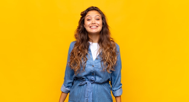 young pretty woman posing against the colored wall