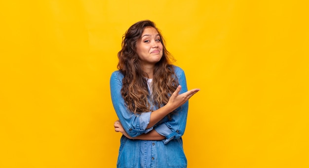 young pretty woman posing against the colored wall